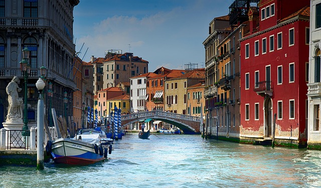 A gondola navigating the iconic canals of Venice, a must-see city for any tour of Italy.