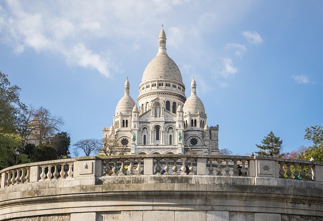 The Eiffel Tower in Paris against a blue sky, a popular destination for travelers looking for budget hotels in France.